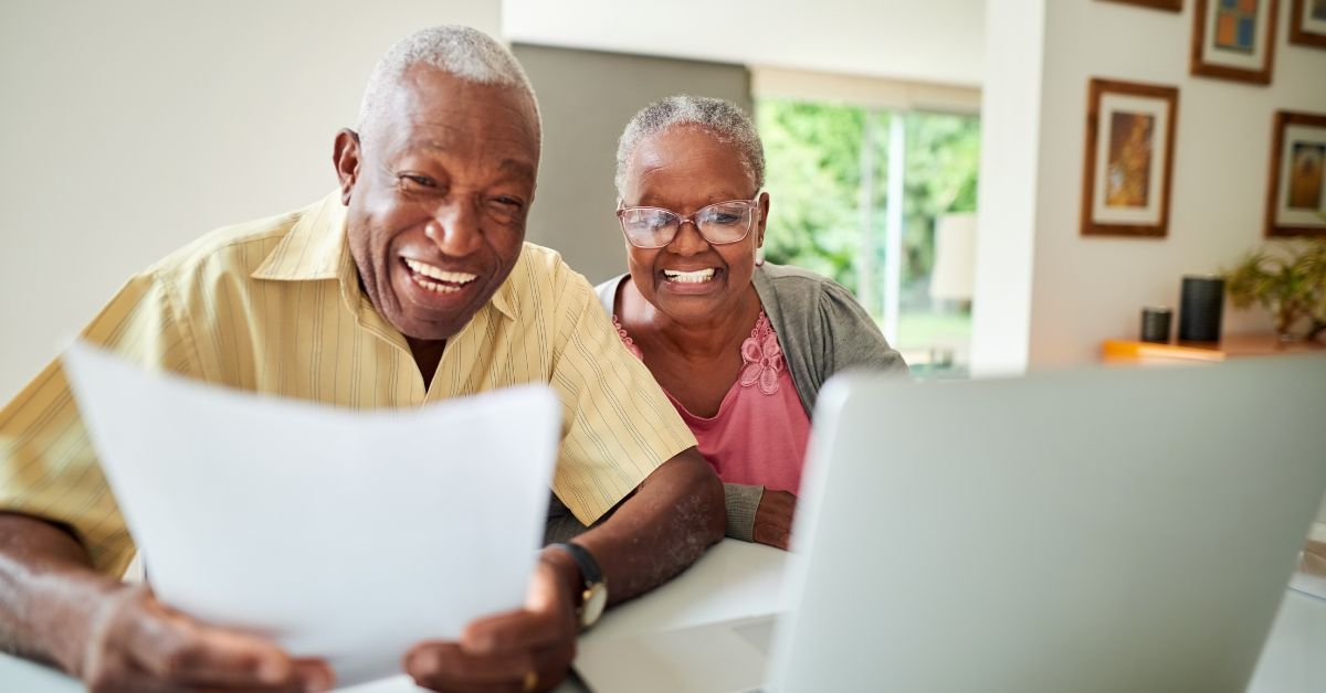 Elder couple decided to retire in Austin, TX, one of the best places to retire, after checking the information on a laptop.