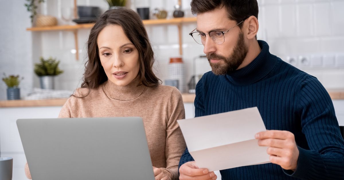 A couple in Dallas, TX reviews an email on a laptop.