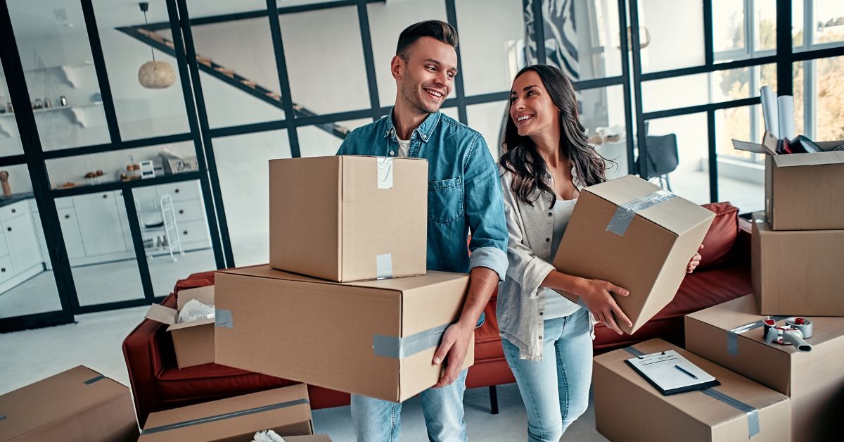 Happy couple lifting boxes moving to one of the best neighborhoods in San Antonio, Texas