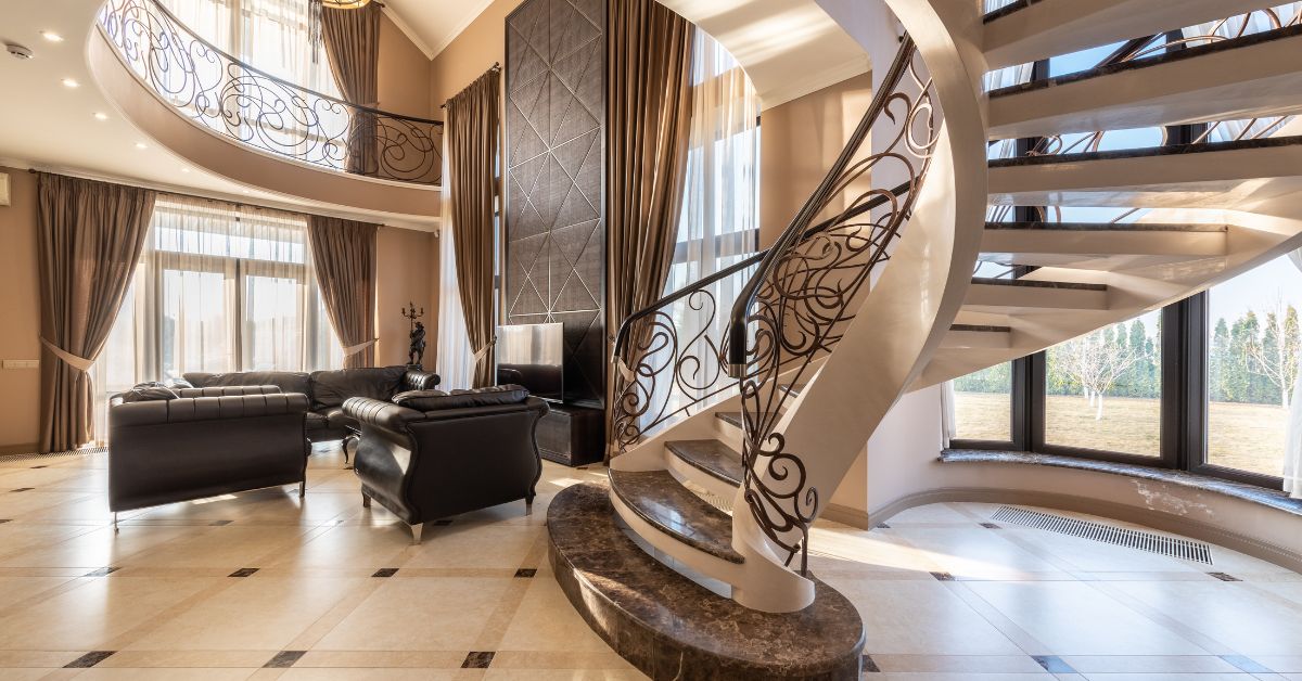 A spacious living room with a spiral staircase in Dallas, TX.